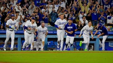 Los Angeles Dodgers players run onto the field to celebrate